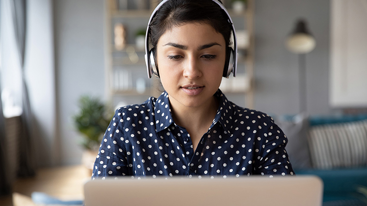 Woman with headphones using laptop